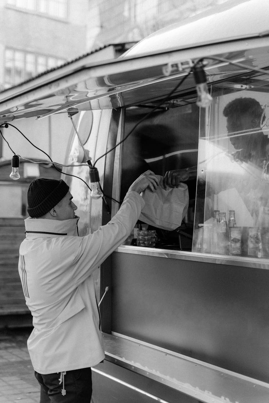 a man buying from a food truck